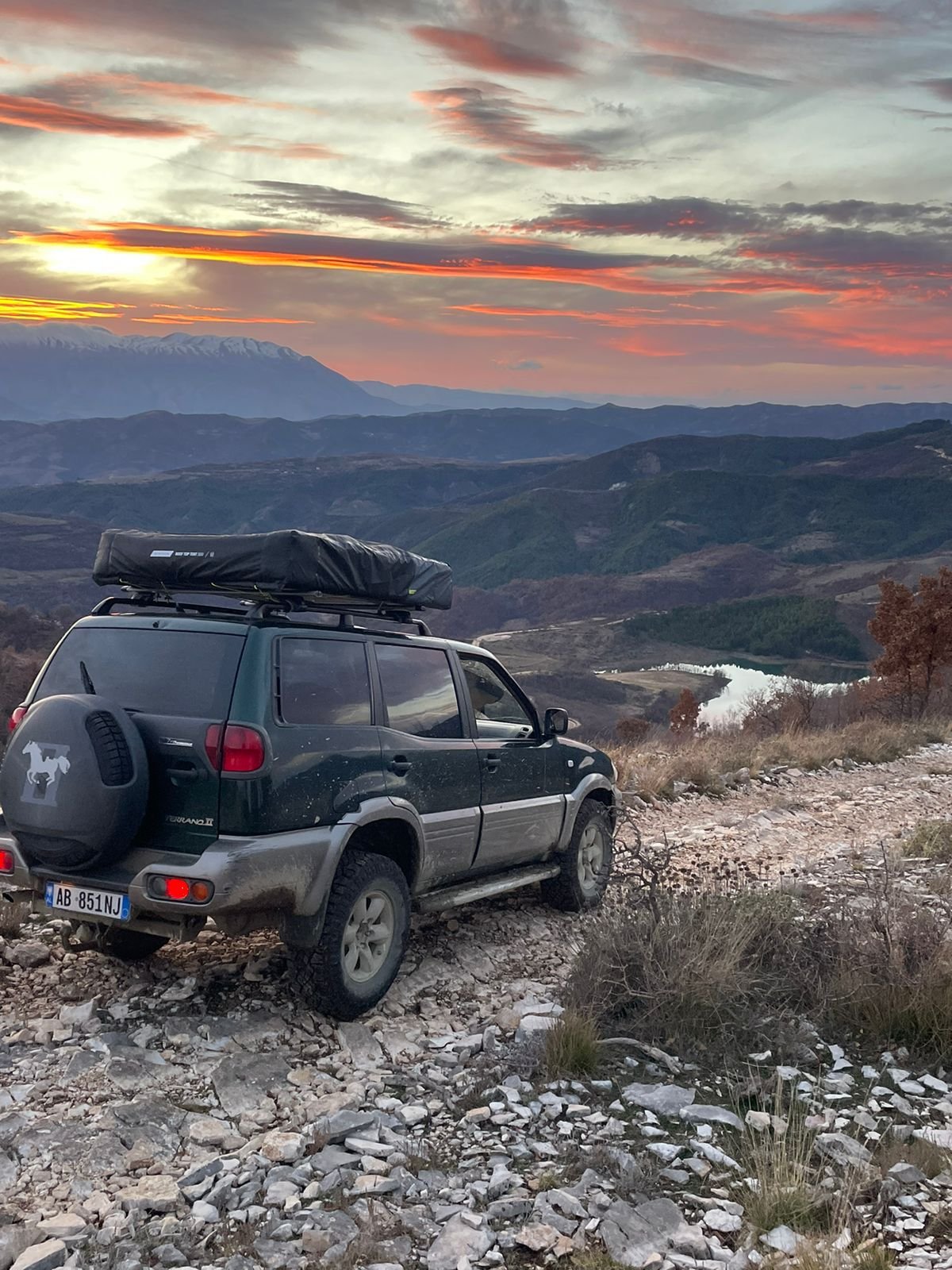 A 4x4 camper in the Albanian rugged mountains going in a camping adventure.